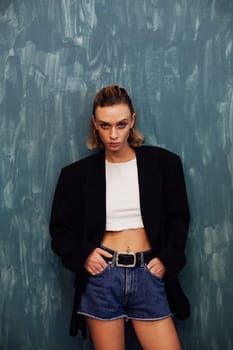 Blonde model posing on a blue background in room