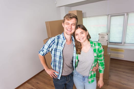 Happy couple moving in a new house indoor