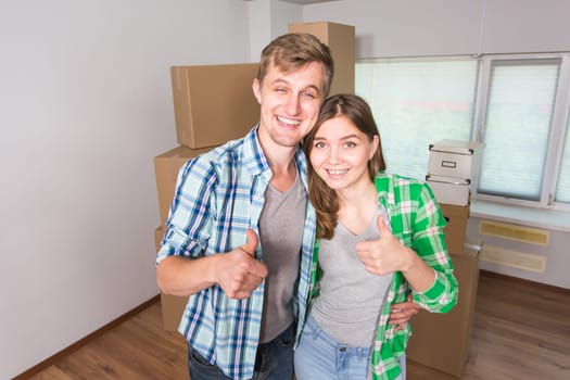 Happy couple showing keys of new home indoor