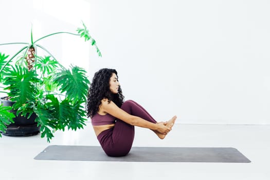 woman doing yoga does stretching exercises for the body female exercises