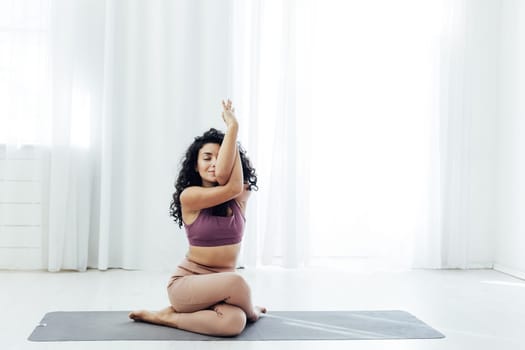 a woman doing yoga acrobat gymnast exercises for weight loss flexibility of the body