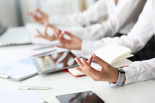 Two businesswoman in office sits at table in relaxed pose closeup. Situation control concept. All right everything is good.