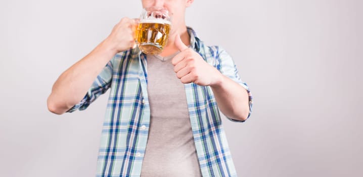 Close up of man holding a mug of beer. Background with copy space.