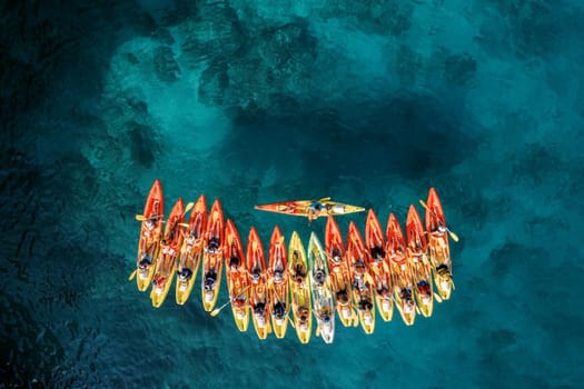 Row of red and yellow kayaks on the turquoise sea. Top view. High quality photo