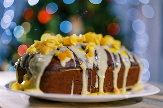 Glazed chocolate Christmas stollen stands on the table. High quality photo