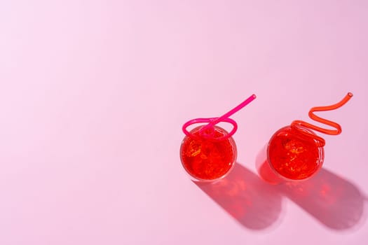 Summer drinks with straws on color background, copy space