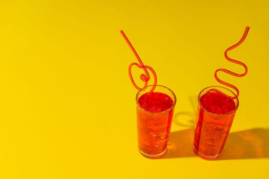 Summer drinks with straws on color background, copy space