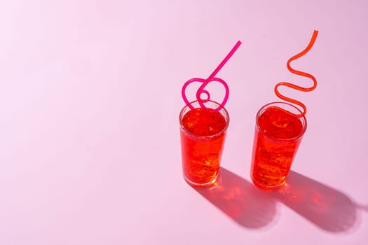 Summer drinks with straws on color background, copy space