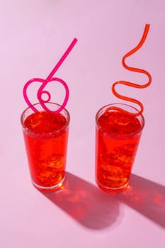 Summer drinks with straws on color background, copy space