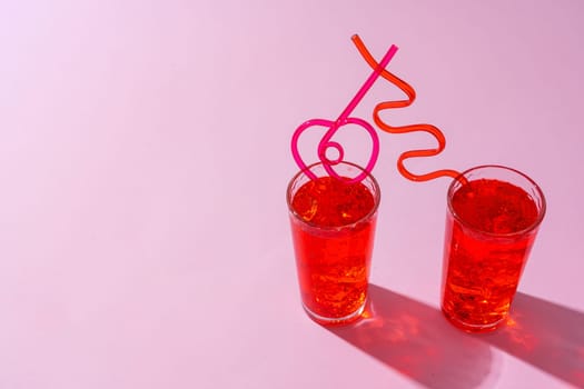 Summer drinks with straws on color background, copy space