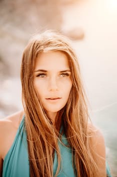 Woman sea green dress. Portrait of a happy woman with long hair in a long mint dress posing on a beach with calm sea bokeh lights on sunny day. Girl on the nature on blue sky background