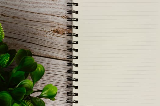 Directly above view of a desk with notepad and plant. Flat lay. Copy space.