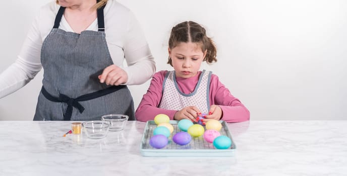 Easter egg coloring. Painting Easter eggs with gold luster.