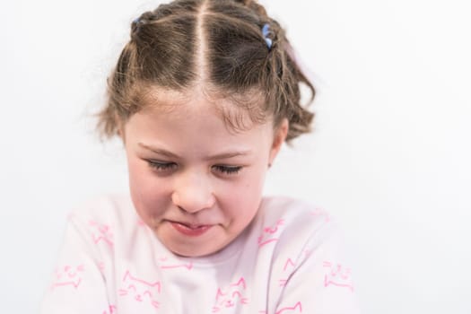 Little girl with rainbow braces having an attitude.