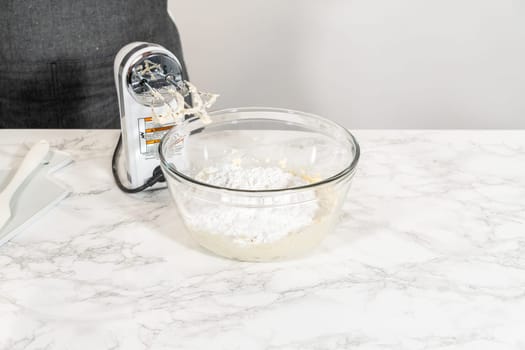 Creating a delectable treat, the process of making homemade cream cheese frosting involves whisking together creamy ingredients to achieve the perfect texture and taste.