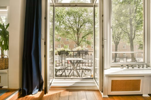 an outside room with wood flooring and sliding glass doors that open to the patio, dining table and chairs