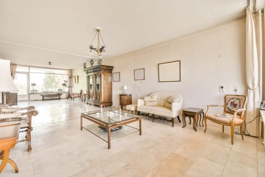 a living room with couches, coffee table and television set in the middle part of the room is empty