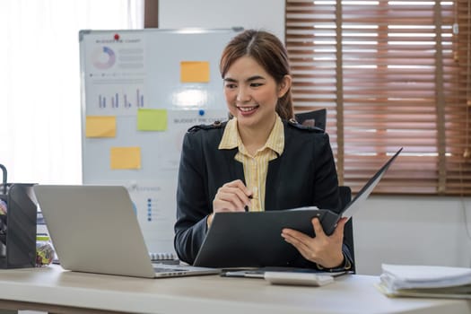 Business woman using calculator for do math finance on wooden desk in office and business working background, tax, accounting, statistics and analytic research concept..