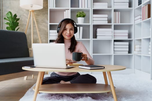 Woman relaxing wearing headphones and drinking coffee at home