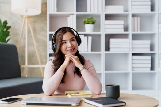 Woman relaxing wearing headphones and drinking coffee at home