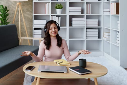 Woman relaxing, wearing headphones and meditating