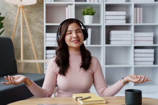 Woman relaxing, wearing headphones and meditating