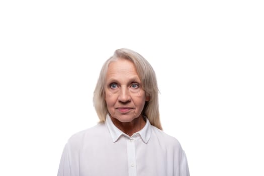65 year old strict European mature woman in a shirt on a white background.