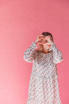 woman showing her heart with her hands