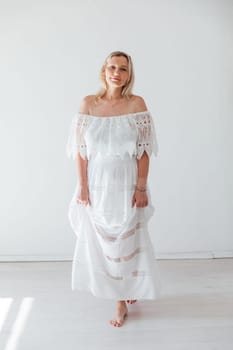 slender blonde woman in summer light dress