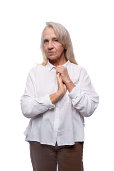 Portrait of an elderly business woman with gray hair in a shirt.