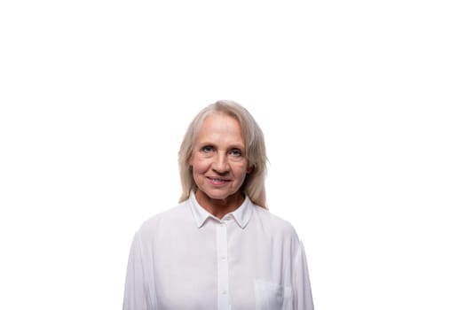 Portrait of an elderly woman with gray hair in a shirt on a white background with copy space.