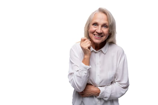 65 year old happy European mature woman wearing shirt on white background.