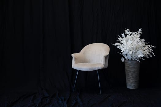 Office chair and white flower on black background