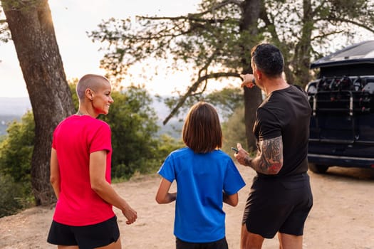 sporty family planning the route of their trail running training, concept of sport with kids in nature and active lifestyle