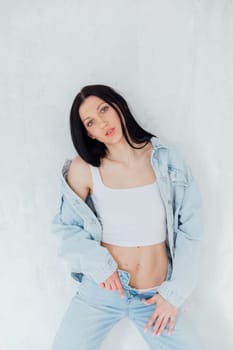 Portrait of a beautiful stoic brunette woman in denim clothes