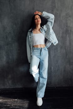 Portrait of a beautiful stoic brunette woman in denim clothes