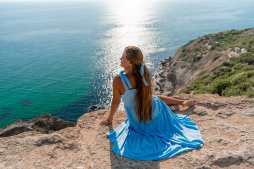 Woman travel sea. Happy woman in a beautiful location poses on a cliff high above the sea, with emerald waters and yachts in the background, while sharing her travel experiences.