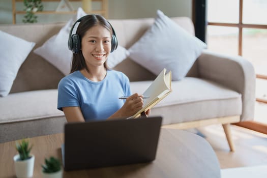 Studying online, beautiful Asian female student or student studying online at home.