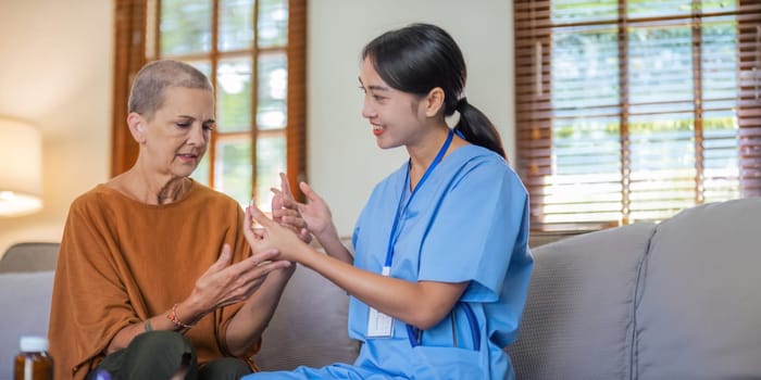 Physical therapist talks with senior patient about pill. and gives a recommendation to a senior female patient explaining medication.