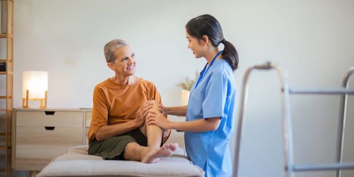 Senior elderly female or patient sitting on sofa in living room the physiotherapy is checking his body in home.