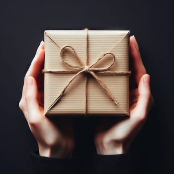 Female hands holding gift box with red