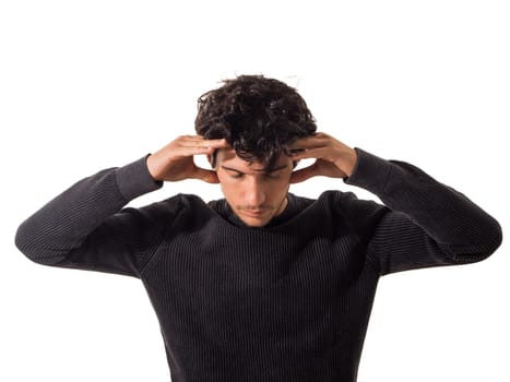 A man is holding his head with his hands, concentrating or meditating, focusing his attention, isolated on white