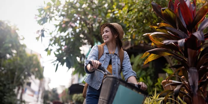 Tourist female asian smile at street with bike cycle on city road.