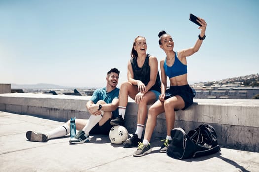 Selfie, fitness and soccer people friends with smartphone for social network update or outdoor wellness post on blue sky mock up. Young accountability sports or sports team with cellphone portrait.