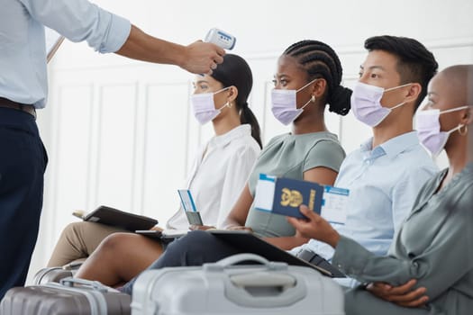 Covid, travel and business people at the airport with thermometer doing temperature checks. Safety, testing and travelling for business during covid 19 pandemic with healthcare worker doing screening.