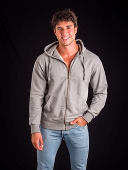 A man in a gray hoodie is posing for a picture