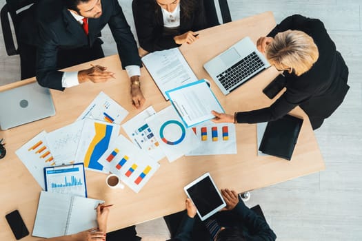 Business people group meeting shot from top view in office . Profession businesswomen, businessmen and office workers working in team conference with project planning document on meeting table . Jivy