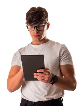 A man in glasses is looking at a tablet