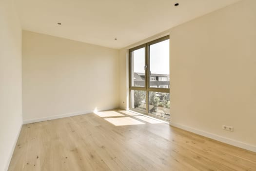 an empty room with wood flooring and large windows looking out onto the cityscapearrons com