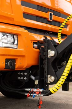 Close-up of the cab of an orange-colored truck.